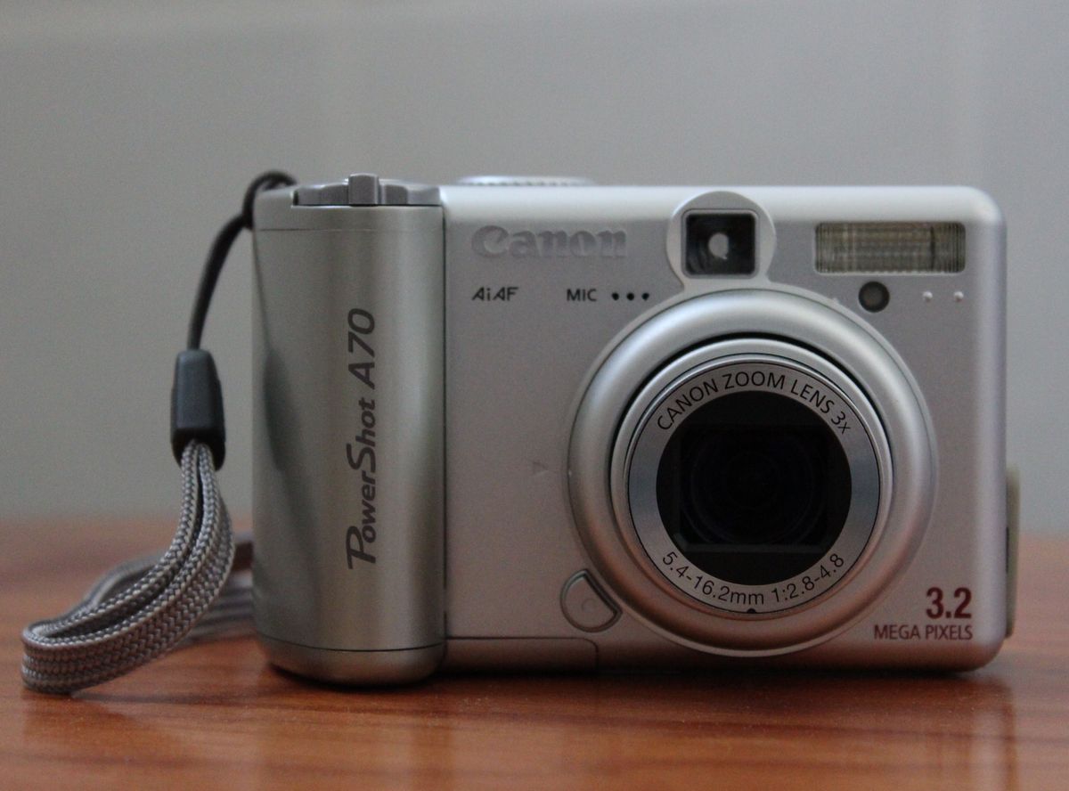 Front view of a silver Canon PowerShot A70 compact camera.